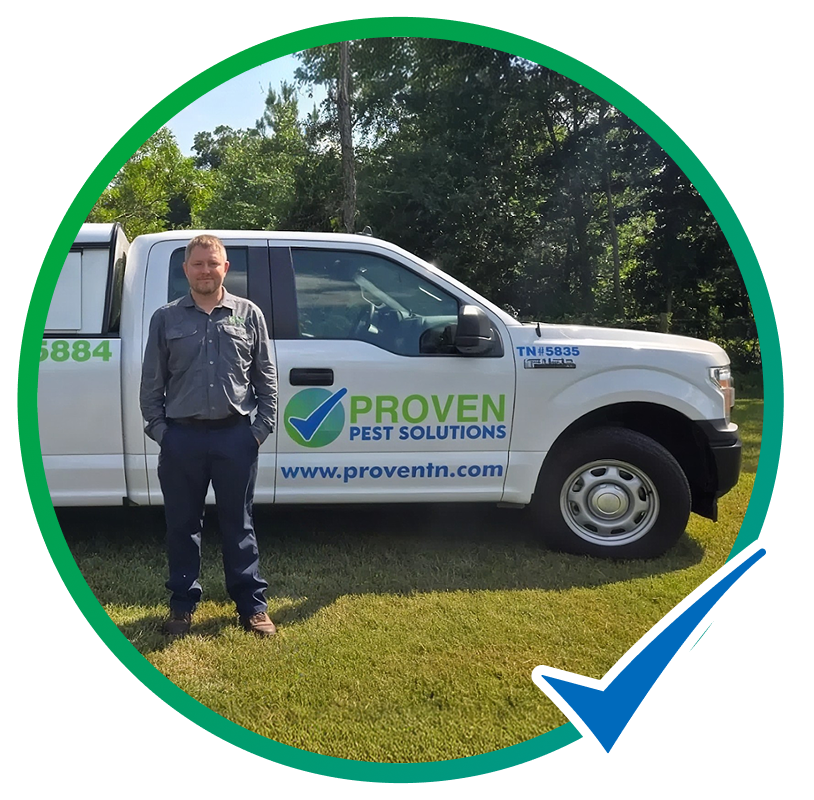 Proven Pest Solutions technician standing beside a company truck